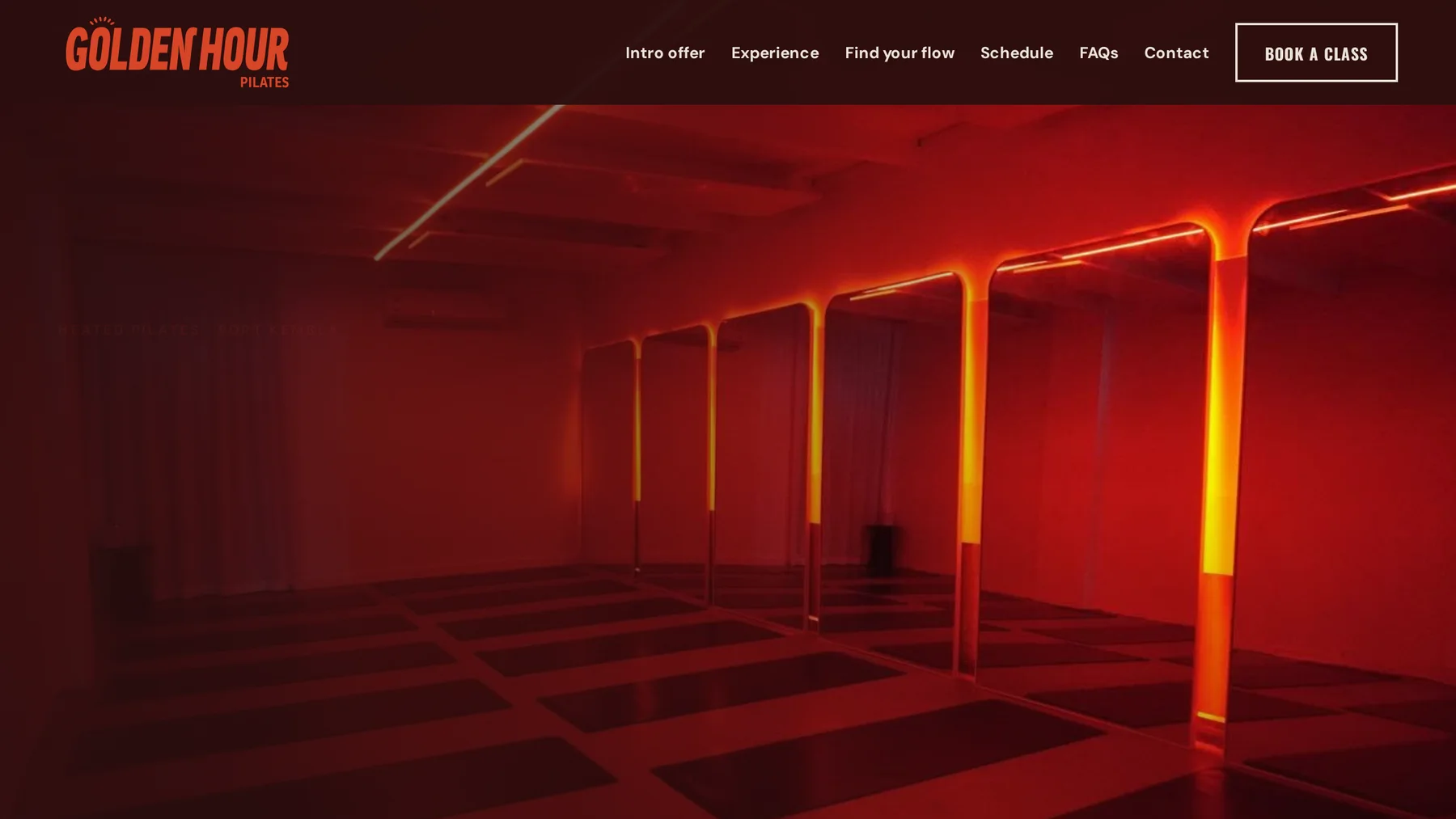 The Golden Hour Pilates homepage with its red-lit studio and class booking navigation.
